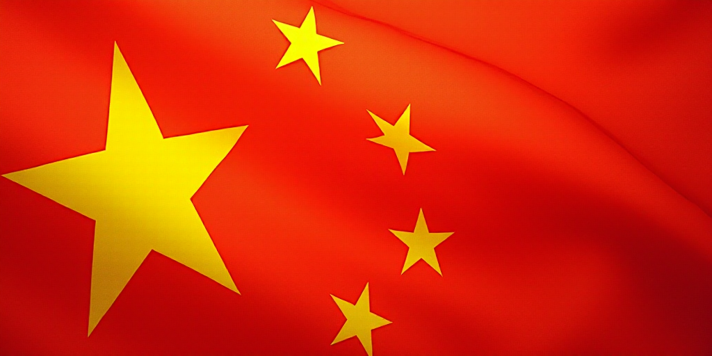a close up of a flag with a red background and a yellow one with white stars on it and a red one wit