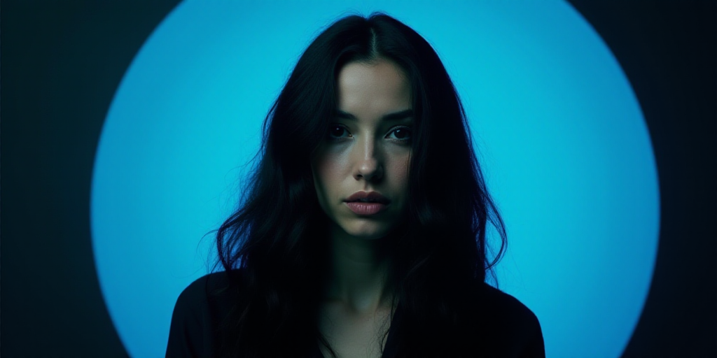 a woman with long hair and a blue circle around her is featured in a blue and black background with