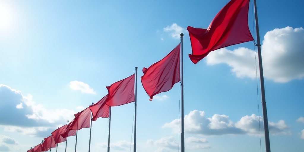 a row of flags blowing in the wind on a cloudy day with a blue sky in the background and a few cloud