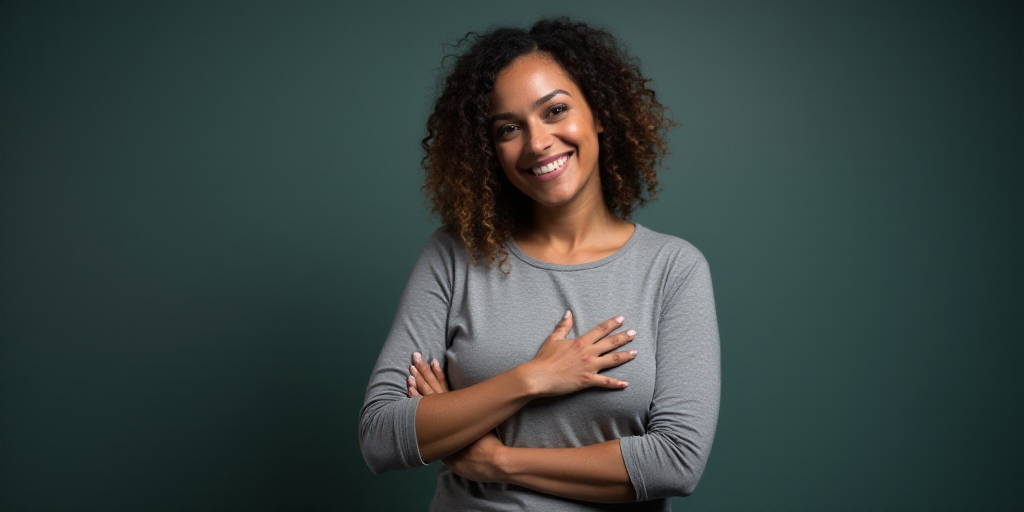 a woman in a gray top is smiling for the camera with her hands folded in front of her chest, Arament
