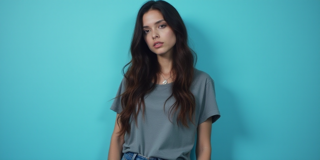 a woman with long hair and a gray shirt is standing in front of a blue background with a black and w