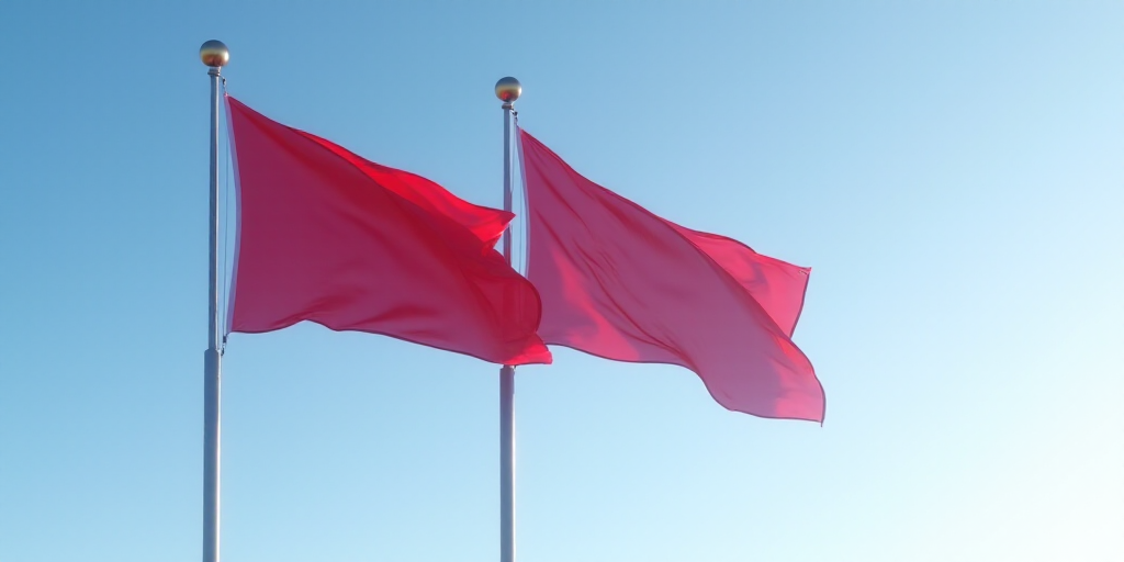 two flags flying in the wind on a clear day with a blue sky in the background and a red one in the f