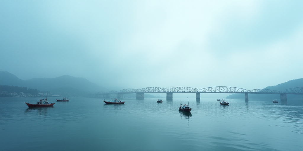 a group of boats floating on top of a body of water next to a bridge under construction on a cloudy
