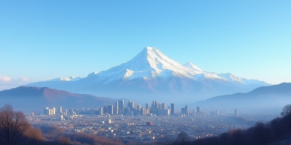 a city with mountains in the background and a blue sky in the foreground with a snow capped mountain