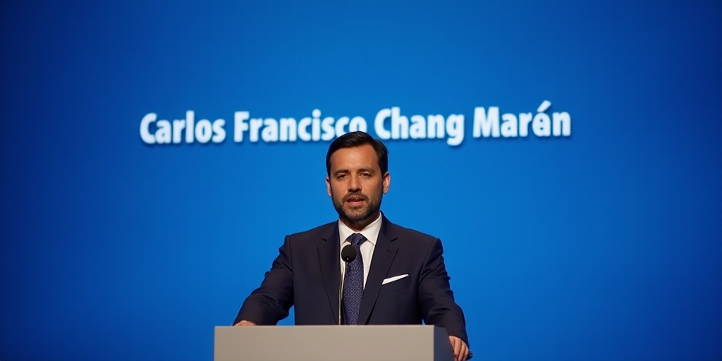 a man standing at a podium with a microphone in front of him and a blue background behind him with a