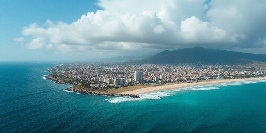 a city on a beach with a blue ocean and a cloudy sky above it and a blue ocean below it, Esaias Bour
