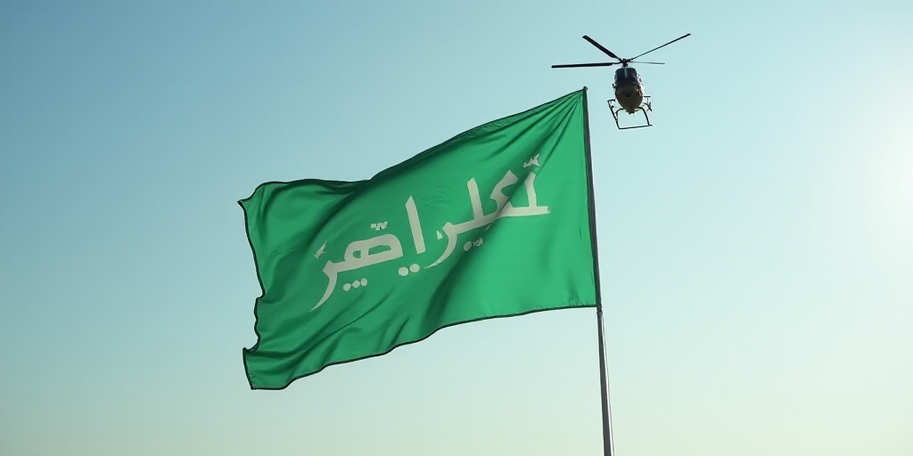 a helicopter flying a green flag with a white writing on it and a helicopter flying in the sky behin